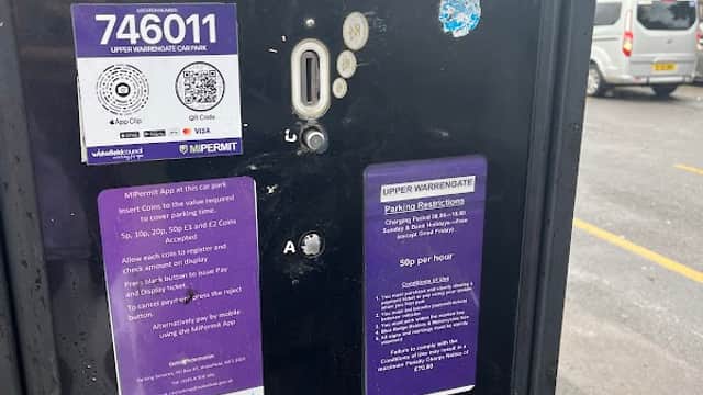 Parking meter with payment instructions and permit details, located at Upper Warrengate Car Park in Wakefield, Yorkshire.