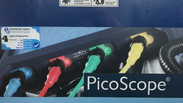 PicoScope branding with colorful diagnostic leads labeled A, B, C, and D, and a technical topics sign.