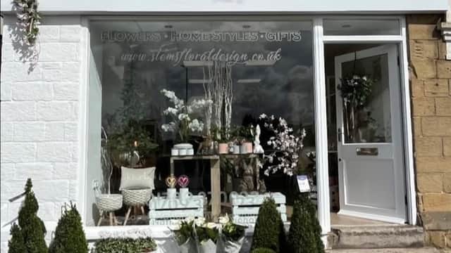 Florist shopfront with "Stems" sign, potted plants, flowers, and decorative items displayed outside in Wickersley.