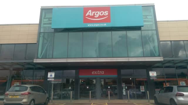 Argos store entrance with large blue signage, located inside Sainsbury's, featuring a modern glass facade.