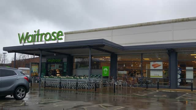 Waitrose & Partners store in Meanwood, Yorkshire, featuring green signage and shopping carts outside.