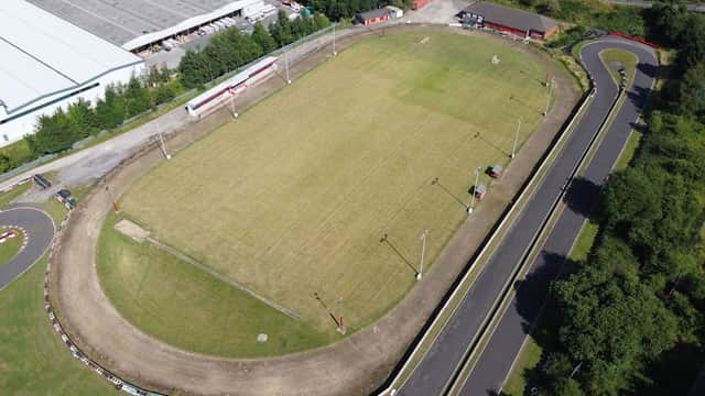 Aerial view of Wombwell Town FC's football pitch, surrounded by trees and nearby buildings in Wombwell, Yorkshire.
