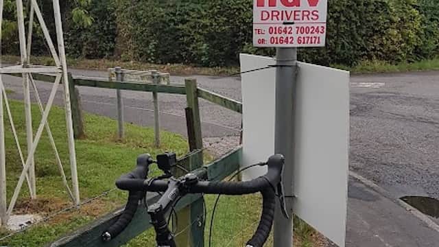 Signpost indicating directions to Faceby, Carlton, and Stokesley, with a "Wanted HGV Drivers" notice from Prestons of Potto.
