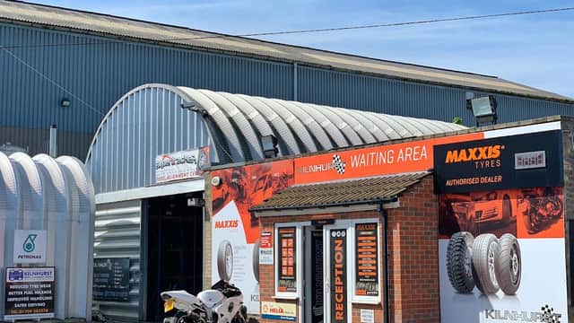 Kilnhurst Tyres garage with a reception area, Maxxis branding, and a motorcycle parked outside.