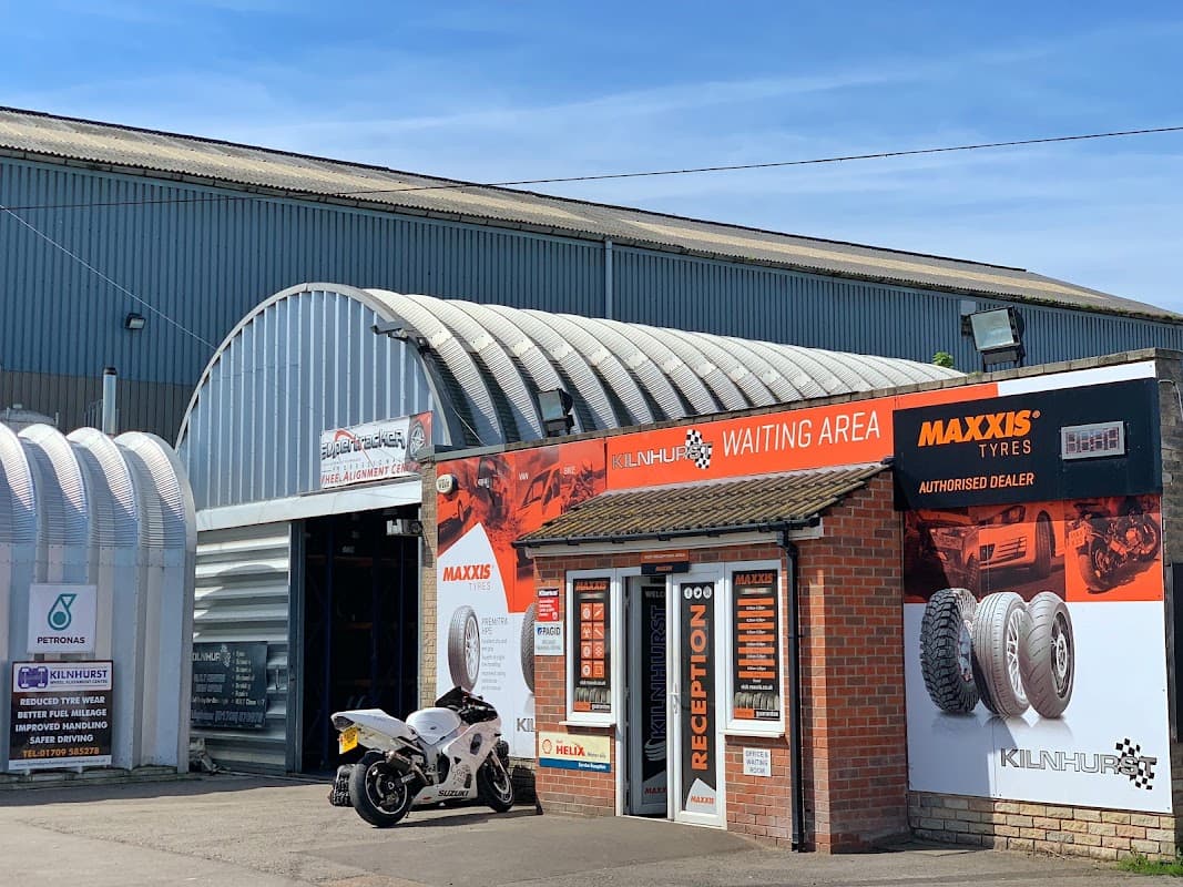 Kilnhurst Tyres garage with a reception area, Maxxis branding, and a motorcycle parked outside.