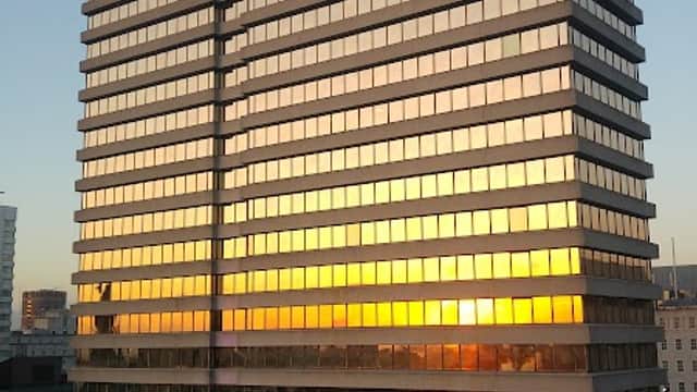The Pinnacle building reflects a sunset, towering over surrounding structures in Leeds, Yorkshire.