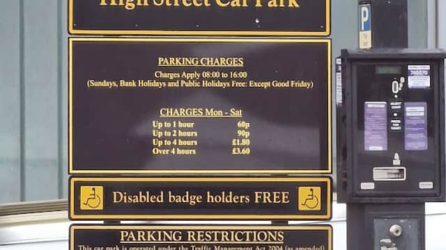 Signage for High Street Car Park with parking charges and restrictions in Normanton, Yorkshire.