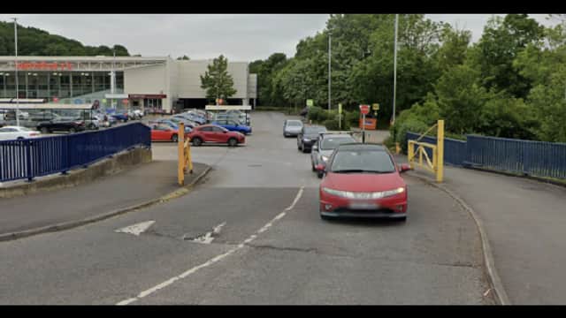 Pay & Display parking area in Nether Edge, Yorkshire, with cars and greenery in the background.