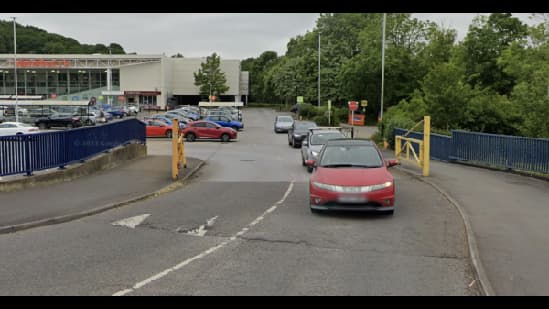 Pay & Display parking area in Nether Edge, Yorkshire, with cars and greenery in the background.