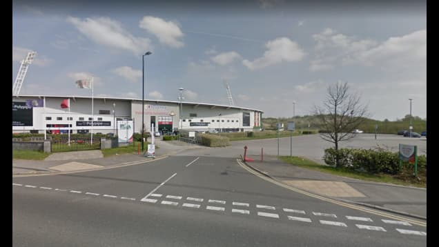 Pay & Display parking area in Doncaster, Yorkshire, near a sports venue with clear skies and green landscaping.