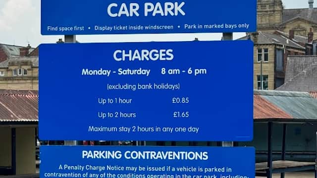 Welcome sign for Whitehall Way Car Park with parking charges, rules, and operating hours displayed prominently.