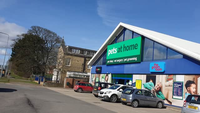 Exterior of Pets at Home shop in Bridlington, featuring a modern design, parking area, and grooming services sign.
