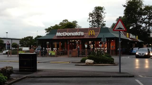 McDonald's restaurant in Bessingby, Yorkshire, with outdoor seating and cars in the parking lot.