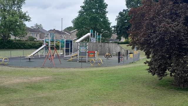 Playground featuring slides, swings, and climbing structures, surrounded by green grass and trees in Ackworth, Yorkshire.