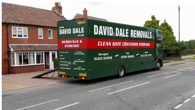 Green removal truck with "David Dale Removals" branding parked by a residential street in Milby, Yorkshire.