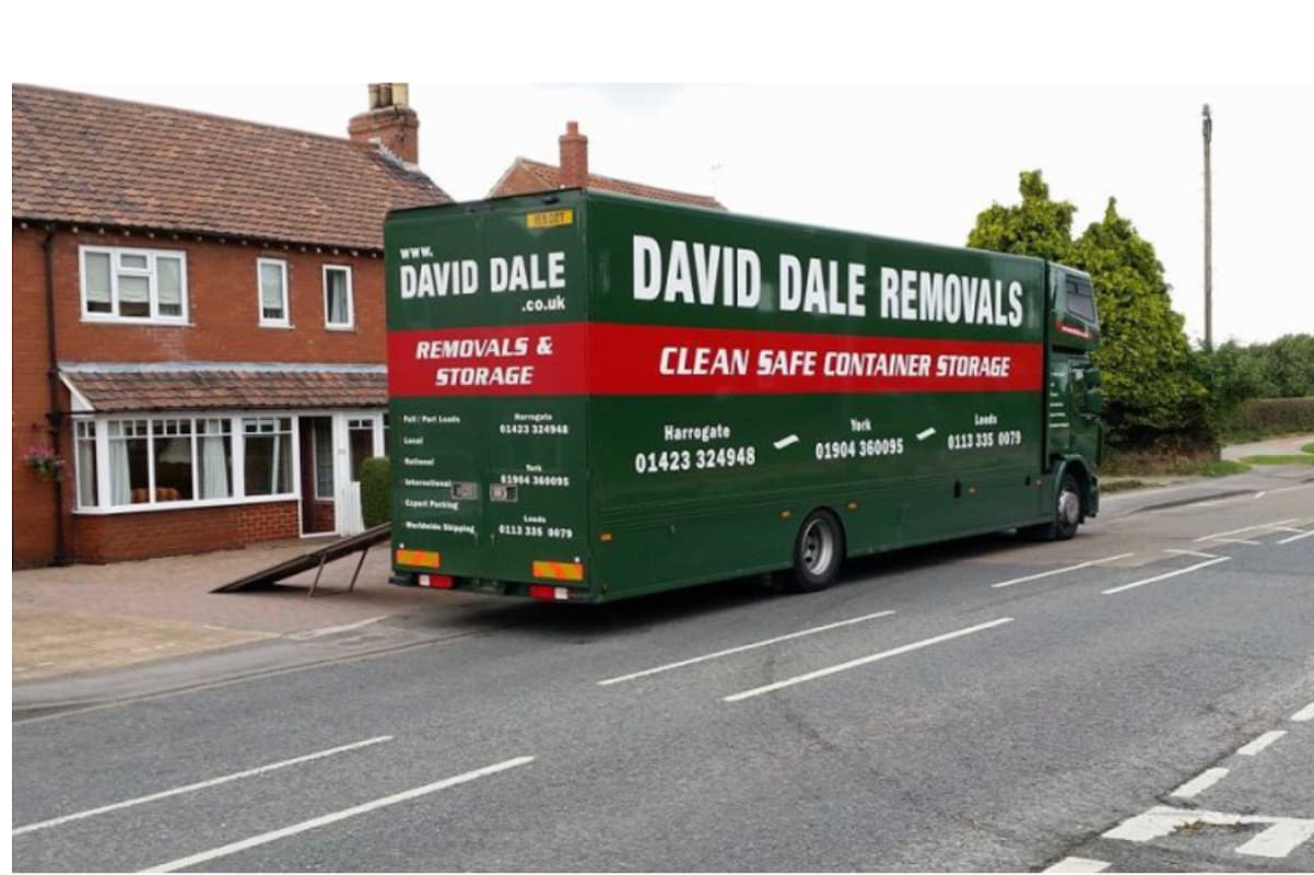 Green removal truck with "David Dale Removals" branding parked by a residential street in Milby, Yorkshire.