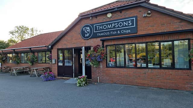 Thompsons Famous Fish & Chips restaurant with a brick exterior, flower baskets, and outdoor seating in Stockton on the Forest.