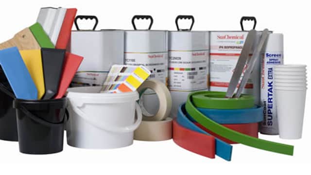 Screen printing supplies including ink, buckets, squeegees, tape, and color swatches arranged neatly.