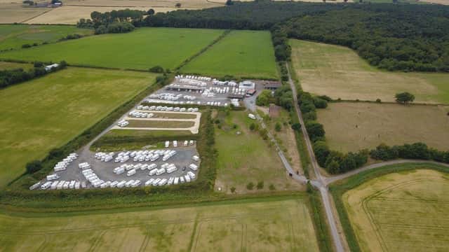 Aerial view of Moorlands Secure Storage, featuring numerous parked vehicles and green fields in North Newbald, Yorkshire.