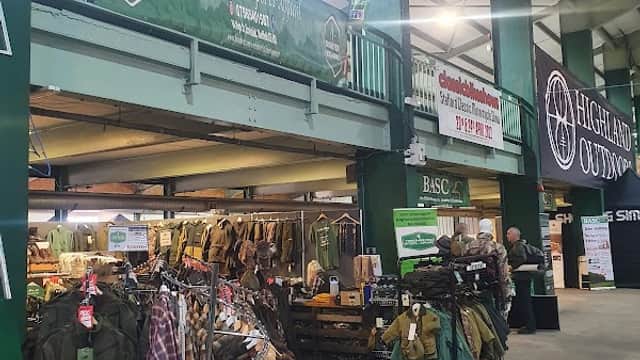Shop interior featuring outdoor apparel, banners for Yorkshire Field Sports and Highland Outdoors, and racks of clothing.