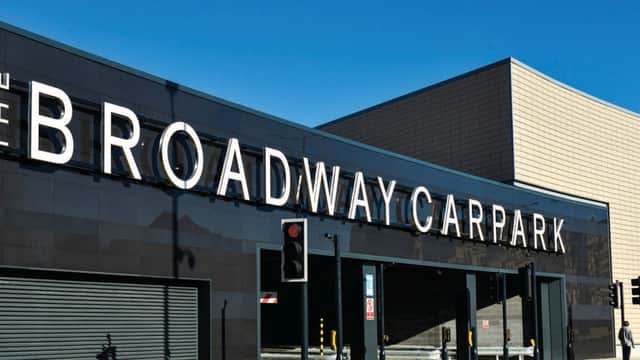 The Broadway Car Park building with large signage, modern architecture, and clear blue sky above.