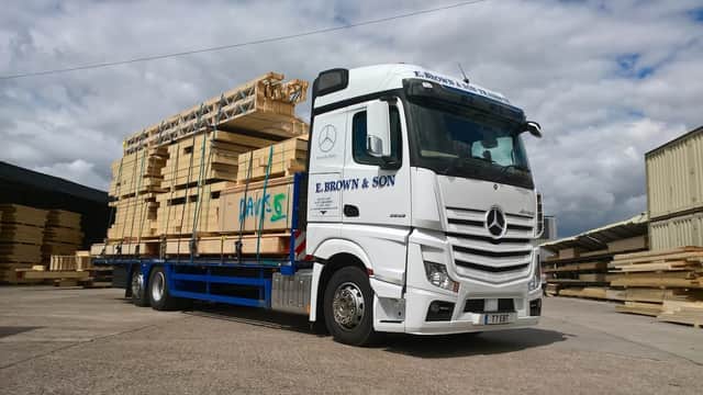 E. Brown & Son truck loaded with wooden pallets, parked in a yard under a cloudy sky in South Cave, Yorkshire.