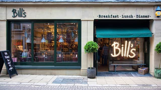 Charming restaurant exterior with green windows, a welcoming sign, and outdoor plants in York, Yorkshire.