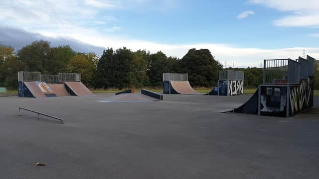 Skate park featuring ramps, a rail, and a spacious concrete area under a cloudy sky in Stocksbridge, Yorkshire.