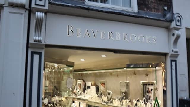 Beaverbrooks jewellers storefront in Beeston, showcasing elegant jewelry displays and a classic brick facade.