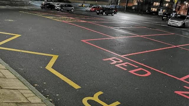 Drummond Street Car Park at night with visible parking spaces marked in red and yellow, and cars parked.