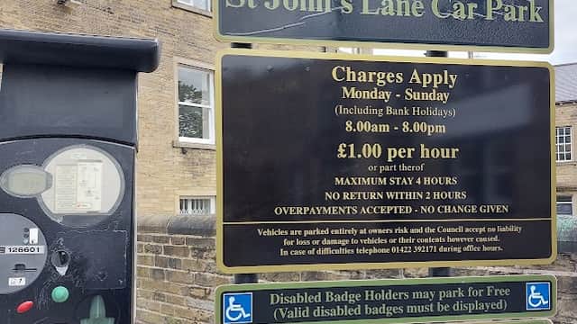 Welcome sign for St John's Lane Car Park, with pay station, parking charges, and conditions displayed.