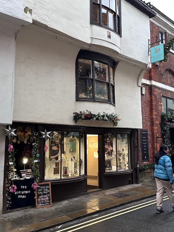 Charming gift shop with festive decorations, showcasing jewelry and a welcoming entrance in York, Yorkshire.
