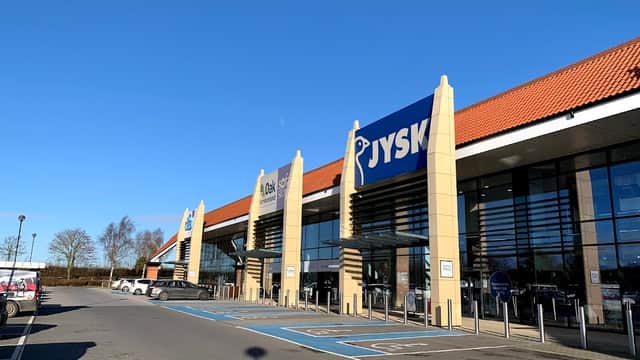JYSK store front at Clifton Moor Retail Park, with clear blue sky and parking spaces in view.