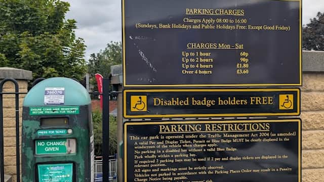 Welcome sign for Prospect Road Car Park with parking charges, restrictions, and a Pay & Display machine nearby.
