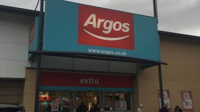 Argos store entrance with large red sign, shoppers outside, and a cloudy sky overhead in Bradford, Yorkshire.