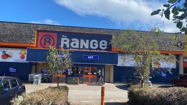 Storefront of The Range in Halifax, featuring a blue exterior, large signage, and a clear sky above.
