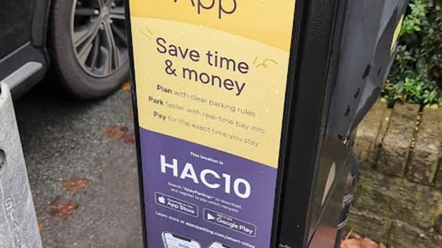 Connected Kerb Charging Station with signage for app-based parking payment and instructions in Harrogate, Yorkshire.