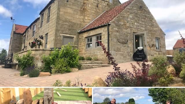 The Jack and Jill Coaching Inn features stone architecture, a sign, and a mini-golf area with a putting green and players.