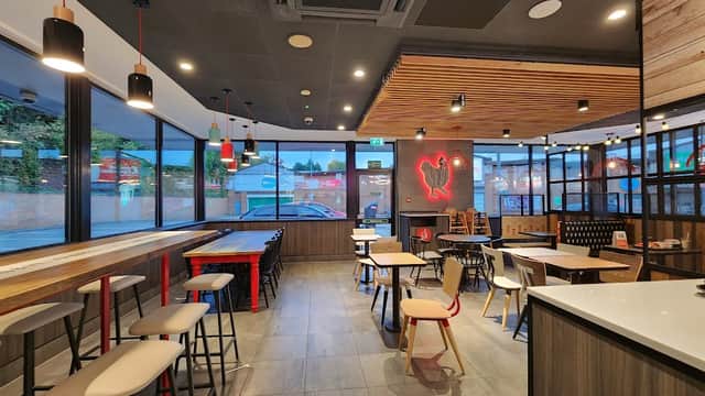 Modern KFC interior with wooden accents, seating areas, and large windows showcasing the Northside Retail Park.