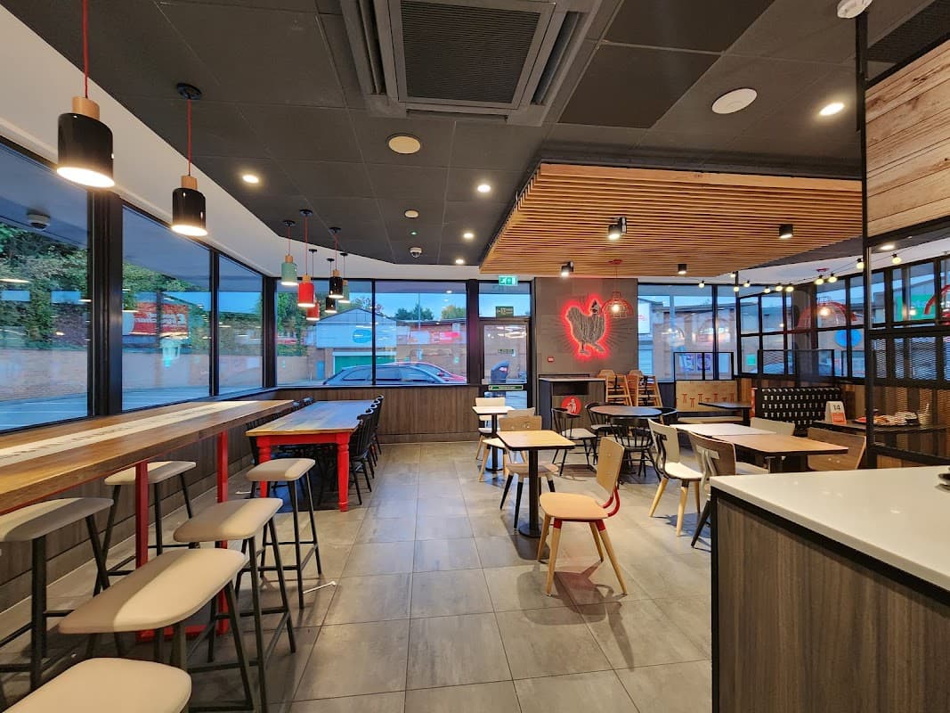 Modern KFC interior with wooden accents, seating areas, and large windows showcasing the Northside Retail Park.