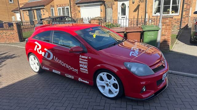 Red modified car with "RnD Motorsport" branding parked on a residential street in Tholthorpe, Yorkshire.
