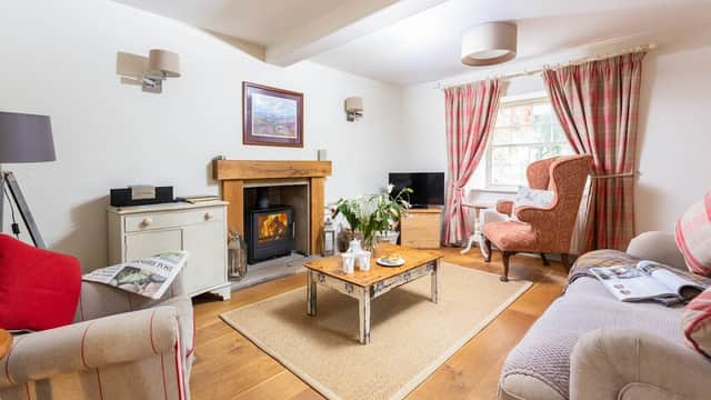 Cozy living room with a fireplace, comfortable seating, and warm decor in Habton House Farm Holiday Cottages.