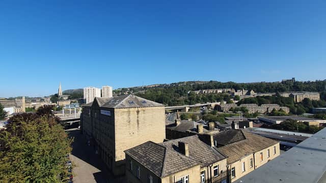 View of Broad Street Plaza car park in Halifax, showcasing buildings, greenery, and a clear blue sky.