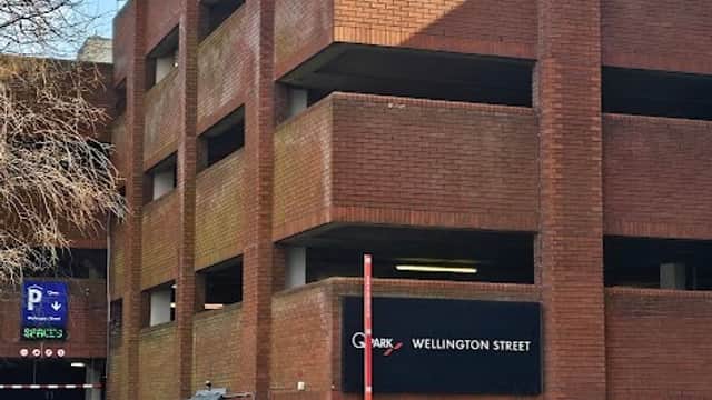 Wellington Street Multi Storey Car Park with red brick exterior and entrance, featuring a car and parking signage.