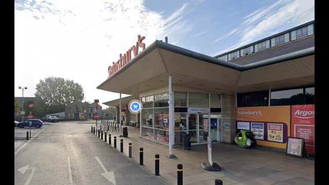 Pay & Display parking near Sainsbury's, with signage and a clear view of the store entrance in Brighouse, Yorkshire.