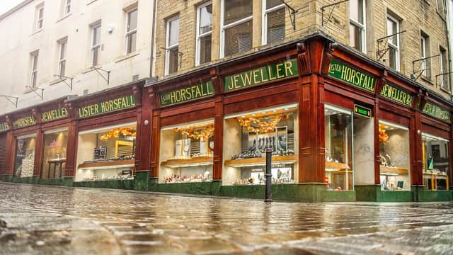 Jewellery shop with large glass windows displaying sparkling items, featuring "Lister Horsfall Jeweller" signage.