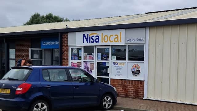 Nisa Local grocery store in Skipsea, Yorkshire, with a blue car parked outside and a laundrette nearby.