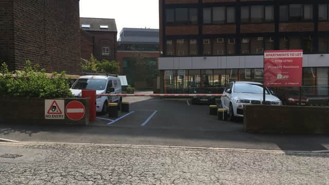 Pay & Display parking area with a "No Entry" sign, vehicles, and a building labeled "Apartments to Let" in York.