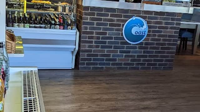 Modern bar interior featuring a brick counter, shelves of drinks, and a cozy atmosphere in Low Hawsker, Yorkshire.