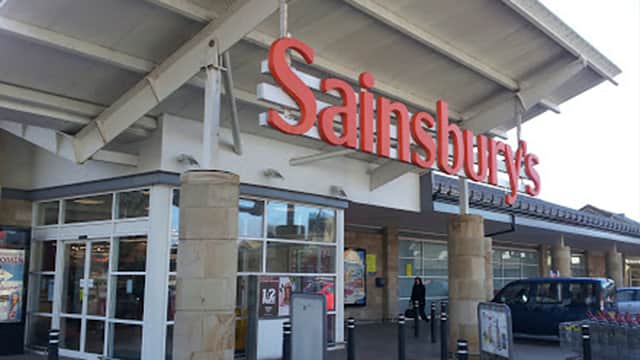 Sainsbury's store entrance with large signage, glass doors, and a modern roof structure in Otley, Yorkshire.